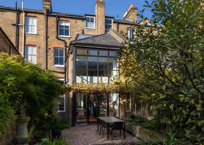 Rear elevation and glazed extension at Archibald Road, viewed from the garden.