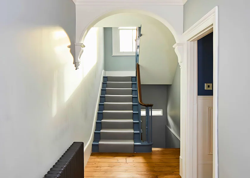 Staircase and double-height circulation space at Fernhurst Road.