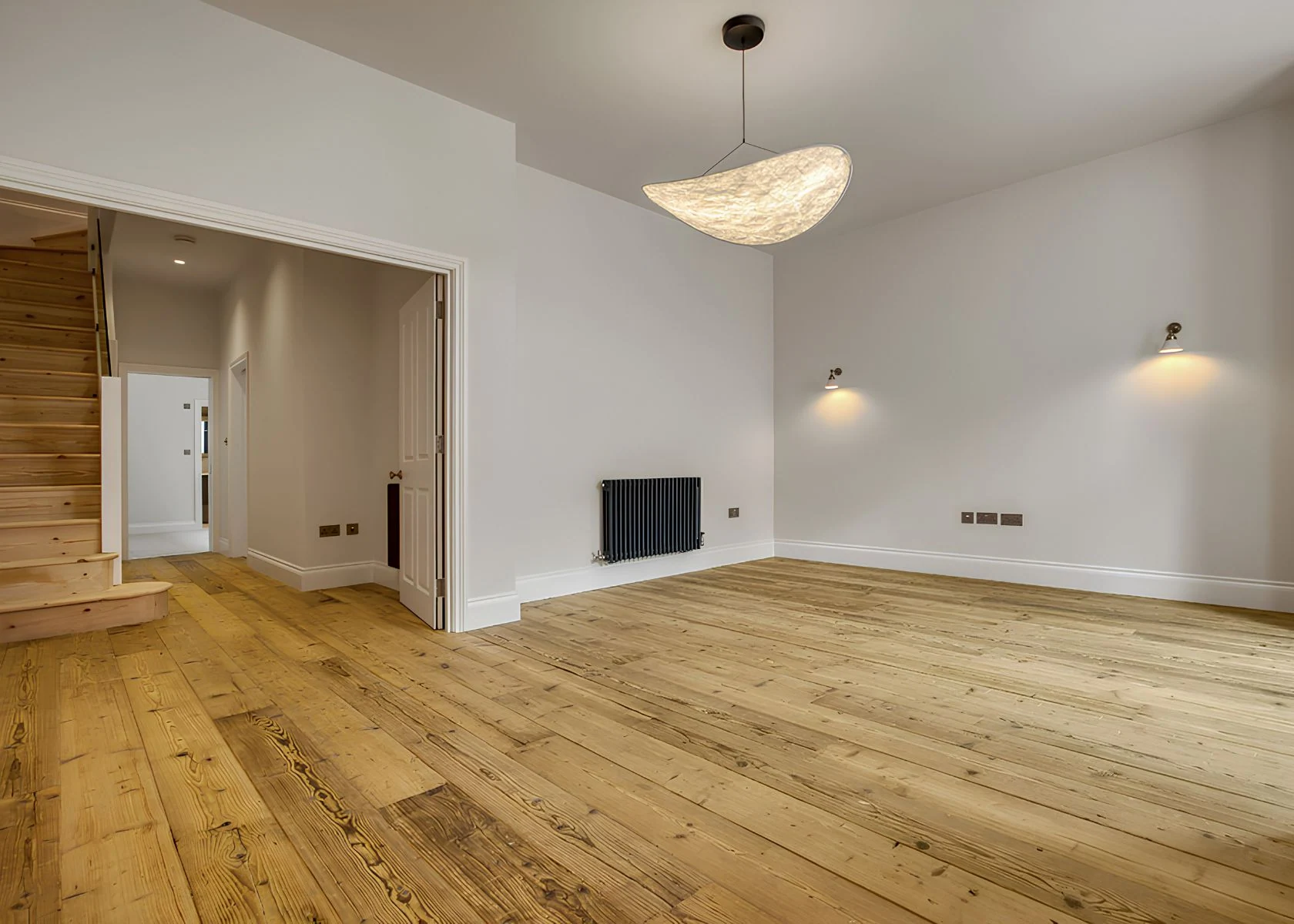 Fernhurst Road: Living-room lighting and timber flooring.