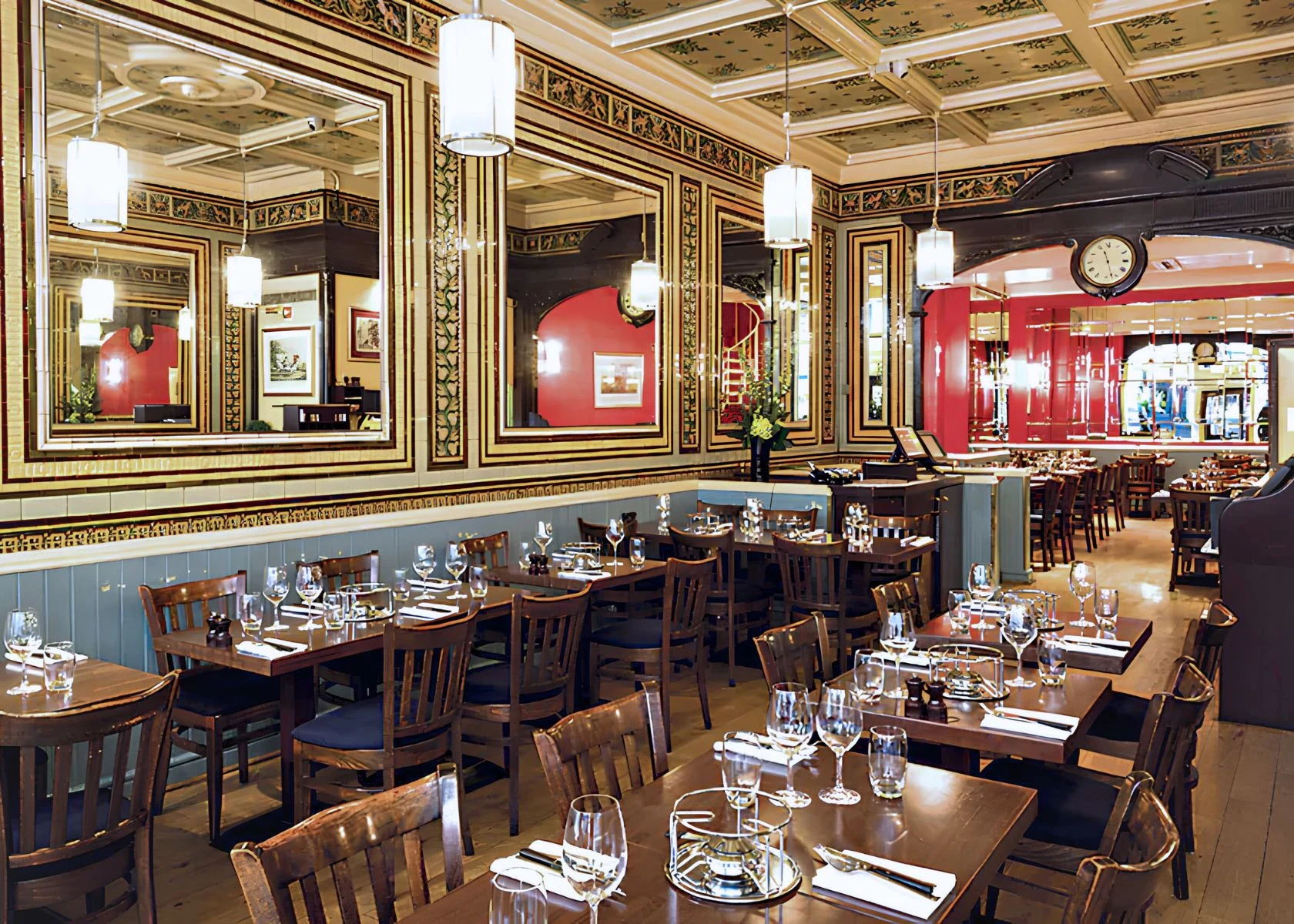 Rowley’s: The main dining room with decorative wall panels and mirrors.