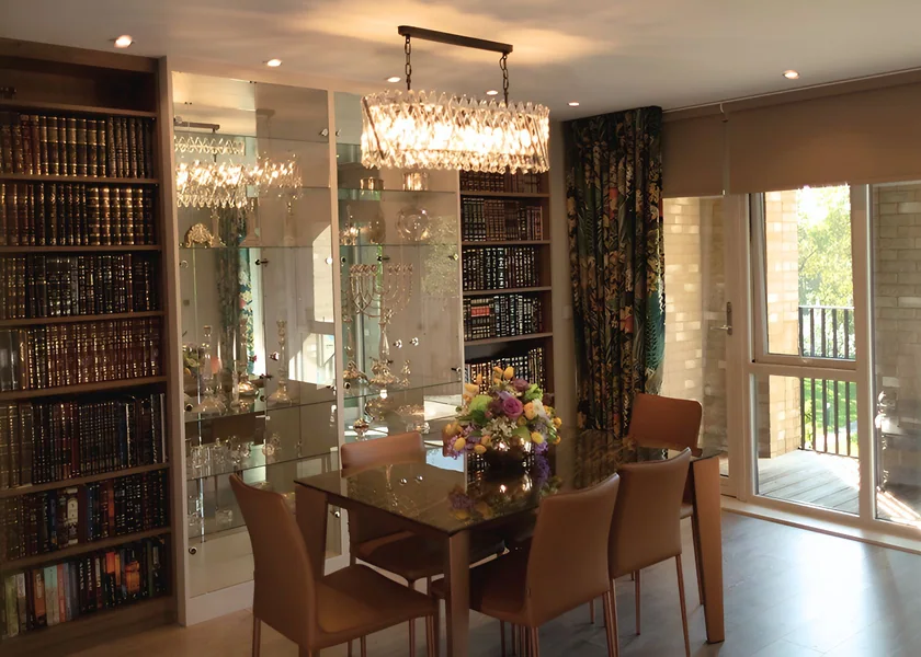 Dining room with integrated bookcases and glazed display cabinets at Tufnell Park.