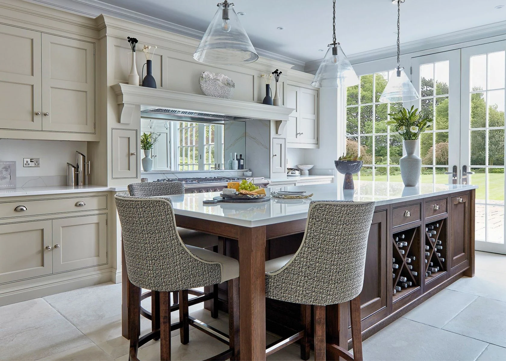 Kitchen island, fitted cupboards and garden-facing windows at Weybridge.