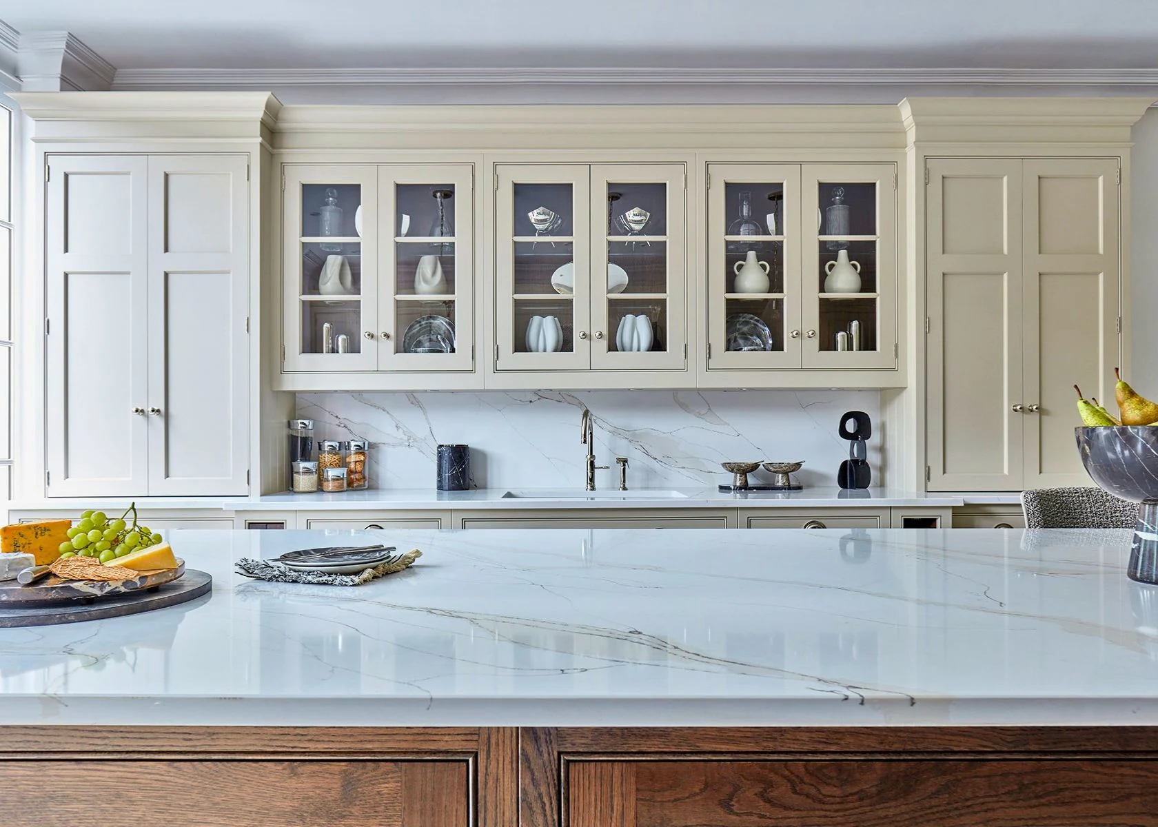 Weybridge: Painted wall cupboards and the stone-effect worktop.
